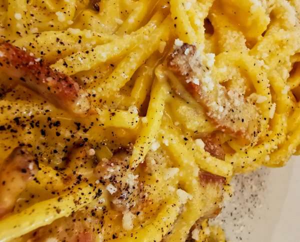 Indulge in the flavors of Rome with a plate of traditional spaghetti carbonara.