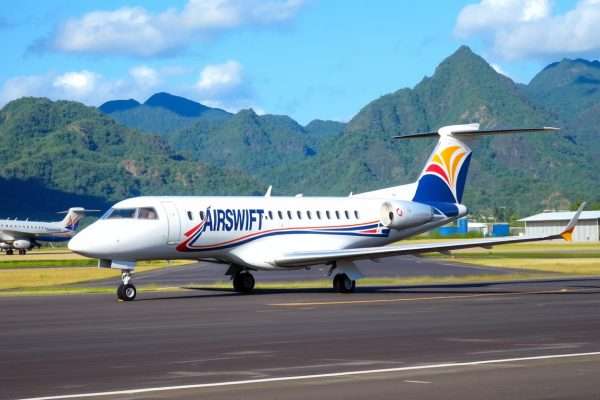 AirSWIFT plane landing at El Nido Airport with tropical landscape in background AirSWIFT plane landing at El Nido Airport with tropical landscape in background