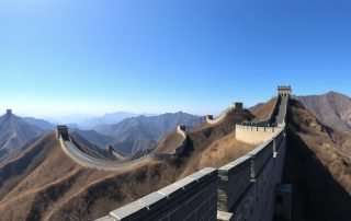 The Great Wall of China stretching across mountains with watchtowers visible, perfect backdrop for defensive puns