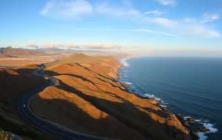 Scenic view of Highway 101 winding along the Pacific coastline with ocean views