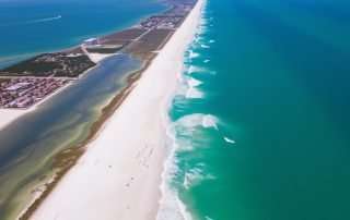 Aerial view of Florida 30A's coastline showing emerald waters and white sand beaches