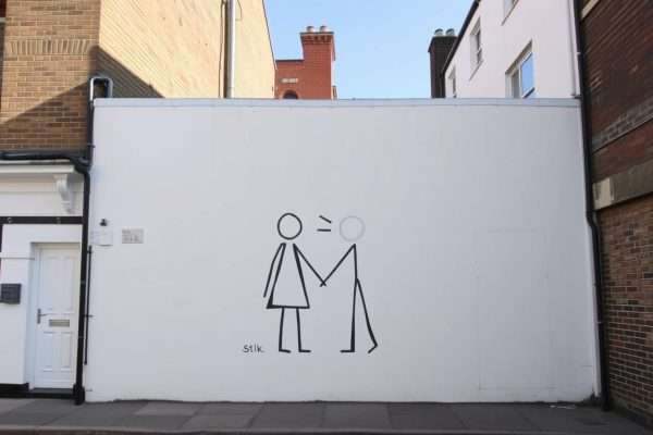 Stik's minimalist mural of two figures holding hands on Princelet Street Stik's minimalist mural of two figures holding hands on Princelet Street