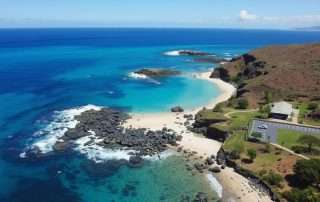 Aerial view of Kaulahao Beach on Maui's North Shore showing the small cove and parking area