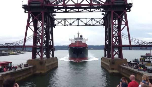 A large cargo ship passing under the Aerial Lift Bridge in Duluth harbor A large cargo ship passing under the Aerial Lift Bridge in Duluth harbor