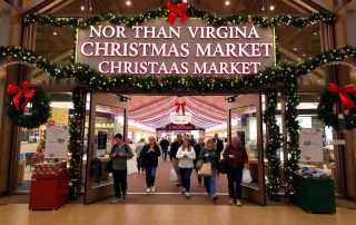 Dulles Expo Christmas Market entrance with festive decorations and crowds of holiday shoppers
