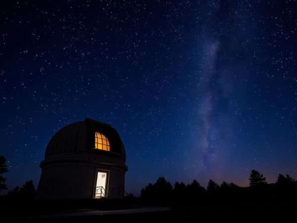 Lowell Observatory telescope in Flagstaff with starry night sky and Flagstaff puns overlay Lowell Observatory telescope in Flagstaff with starry night sky and Flagstaff puns overlay