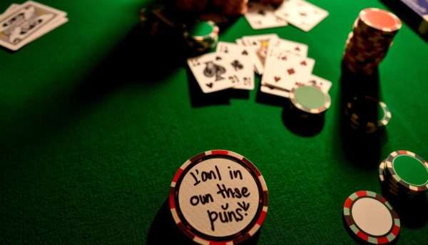 Poker table with cards and chips with a pun written on a chip Poker table with cards and chips with a pun written on a chip