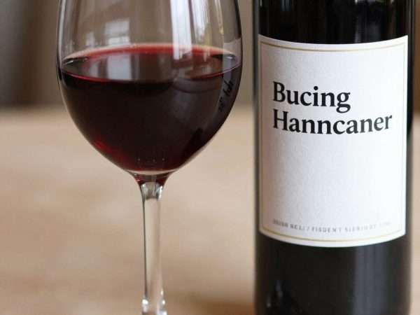 A glass of red wine with a punny wine label A glass of red wine with a punny wine label