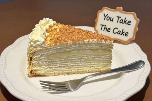 A slice of cake with a fork and the text 'You Take The Cake' A slice of cake with a fork and the text 'You Take The Cake'