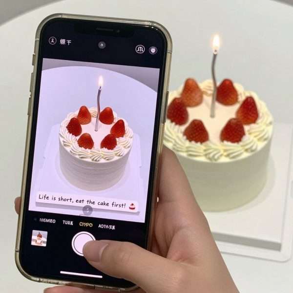 A smartphone taking a photo of a cake with Instagram-style filters and caption options A smartphone taking a photo of a cake with Instagram-style filters and caption options