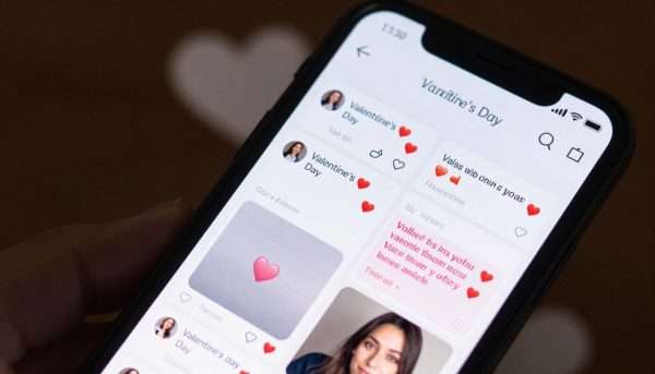 Smartphone displaying Valentine's Day social media posts with puns Smartphone displaying Valentine's Day social media posts with puns
