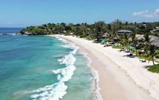 Aerial view of Geger Beach in Nusa Dua, Bali showing pristine white sand and turquoise waters