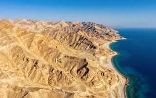 Aerial view of Sinai Peninsula landscape showing desert terrain meeting the Red Sea coastline
