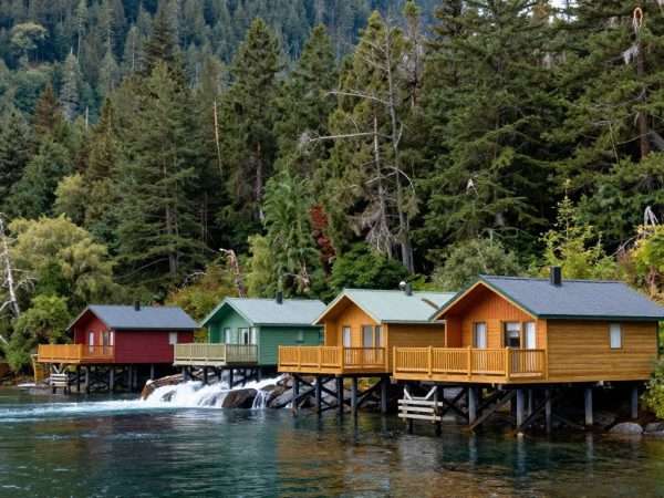 Nimmo Bay Wilderness Resort cabins nestled between forest and sea Nimmo Bay Wilderness Resort cabins nestled between forest and sea