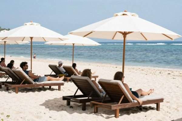 People sunbathing on loungers at Geger Beach People sunbathing on loungers at Geger Beach