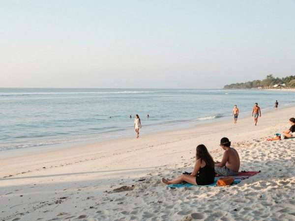 Tourists enjoying a peaceful morning at Geger Beach with few crowds Tourists enjoying a peaceful morning at Geger Beach with few crowds
