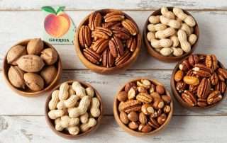 Assortment of nuts in Georgia including pecans and peanuts displayed in rustic wooden bowls