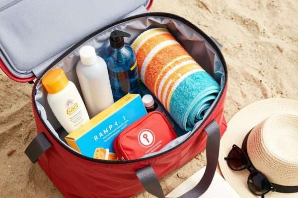 Beach bag packed with essentials for a day at the beach Beach bag packed with essentials for a day at the beach