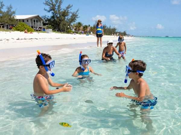 Children playing and snorkeling at Key Largo beach with family Children playing and snorkeling at Key Largo beach with family