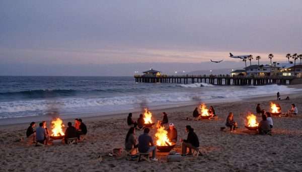 Dockweiler Beach with bonfires on sand at sunset Dockweiler Beach with bonfires on sand at sunset