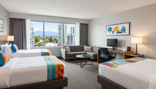 Family-friendly hotel room with two beds and sitting area Family-friendly hotel room with two beds and sitting area