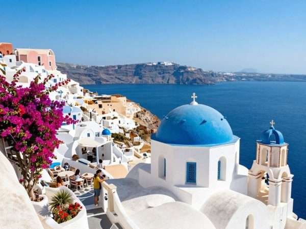 Santorini Greece white buildings and blue domes overlooking Aegean Sea in May Santorini Greece white buildings and blue domes overlooking Aegean Sea in May