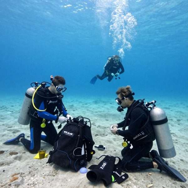 Scuba divers preparing equipment on LA beach Scuba divers preparing equipment on LA beach