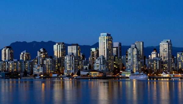Vancouver city skyline at twilight with lights reflecting on water Vancouver city skyline at twilight with lights reflecting on water