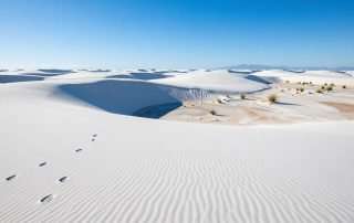 White Sands National Park with rolling white gypsum dunes under bright blue sky in New Mexico